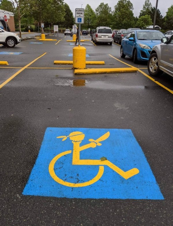 handicap parking sign with pirate sword