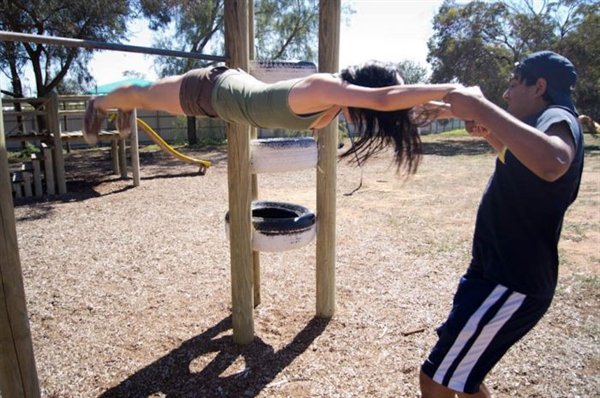 guy holding girl up at a jungle gym