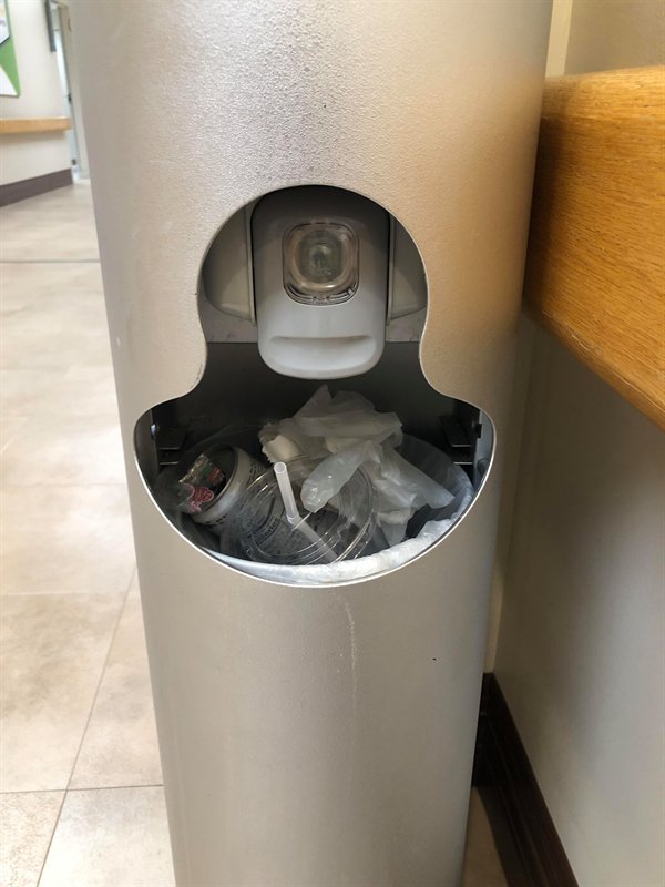 hand sanitizer station installed inside a trash can