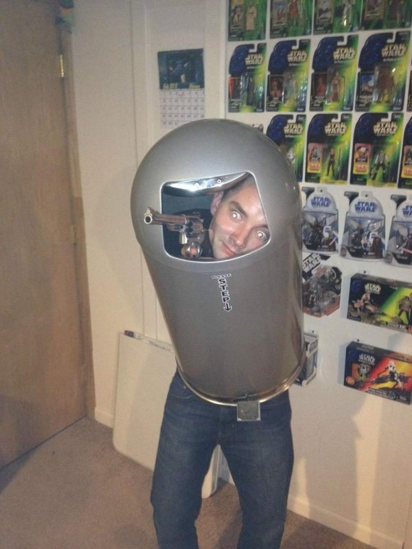 guy wearing a trash can and holding a gun