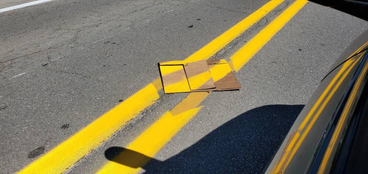 yellow road divider lines painted on crooked
