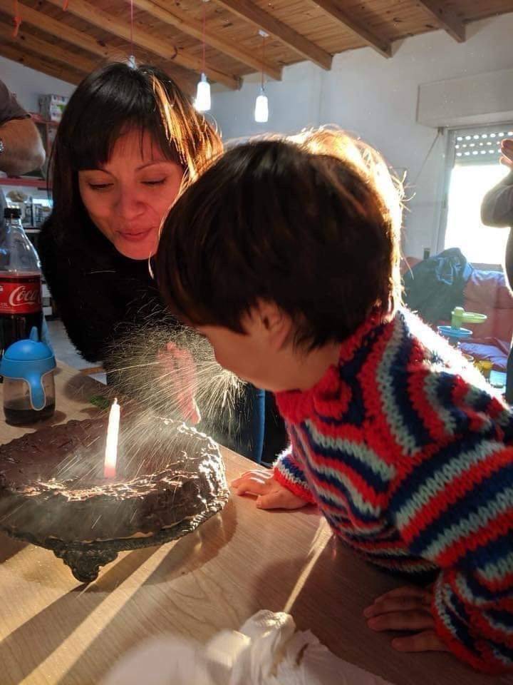 child spitting on birthday cake