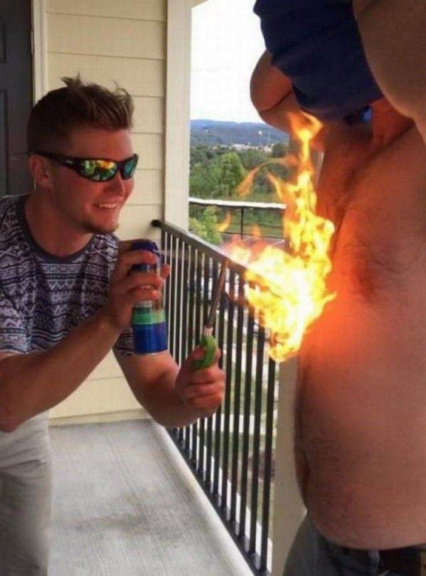 guy lighting his friend's chest hair on fire with a lighter and a can of aerosol sunblock
