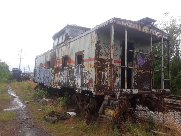 old abandoned train car with rust and graffiti