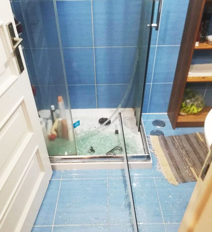 broken glass shower door in bathroom