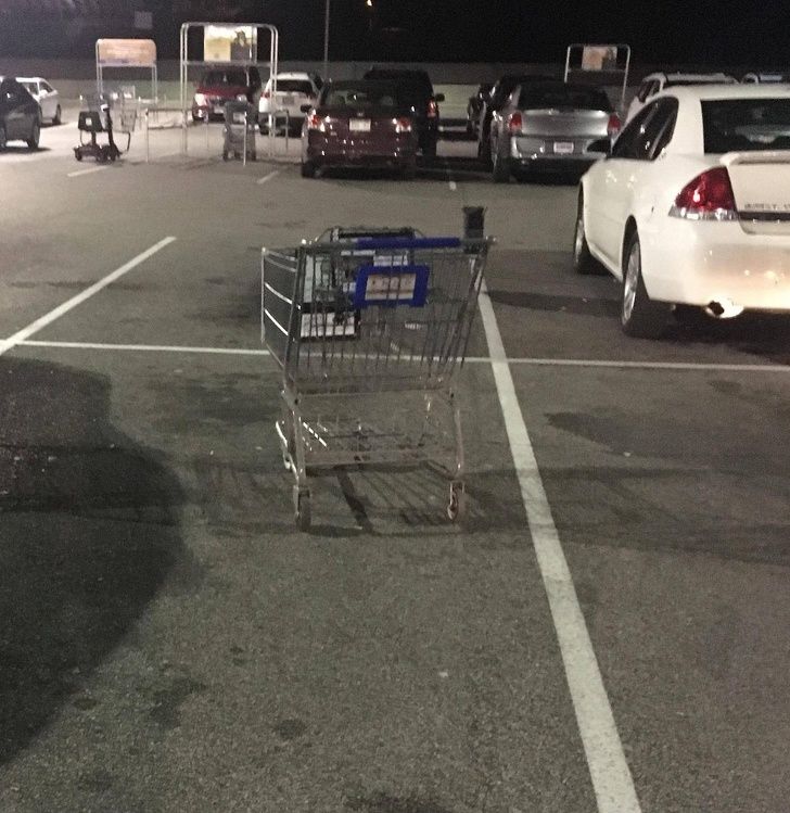 shopping cart left in middle of parking spot