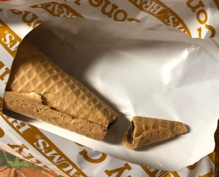 chocolate top of ice cream cone broken off inside package