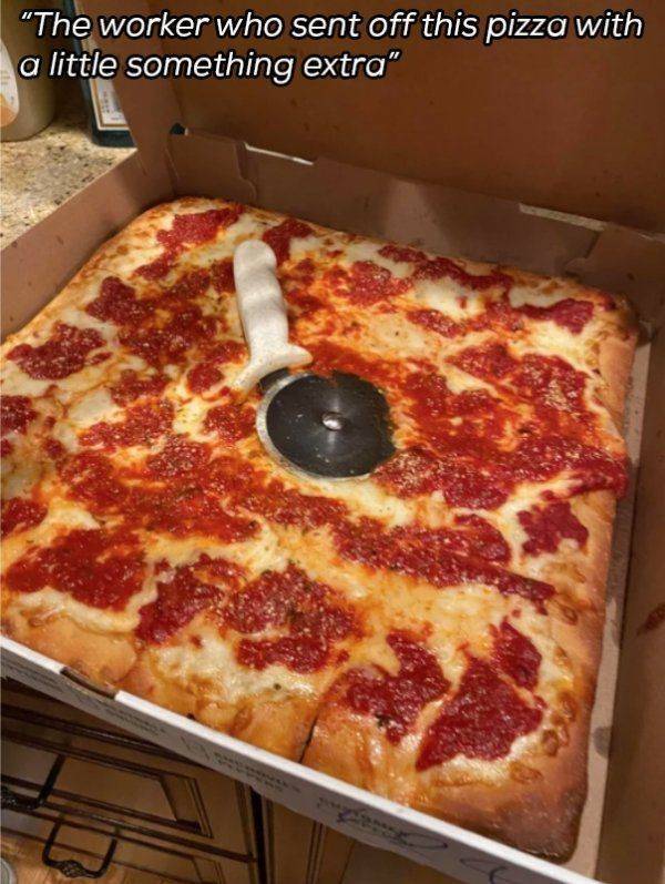 pizza cutter fell on top of the pizza now it's covered in grease