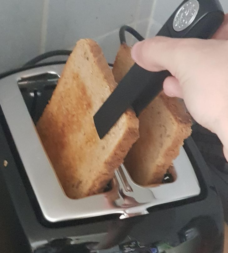 toaster with tongs for picking up the toast