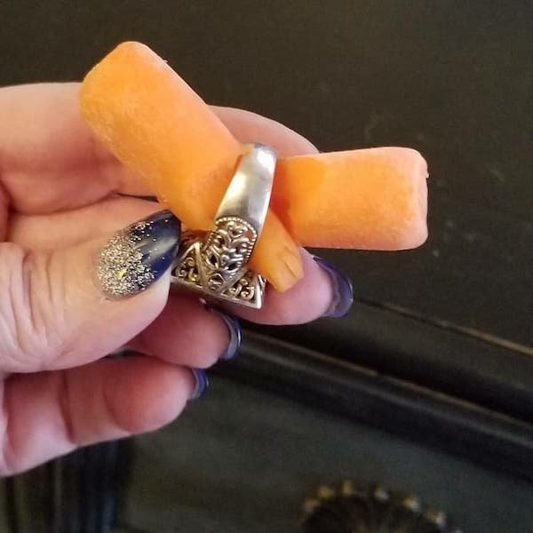 woman holding two carrot engagement ring