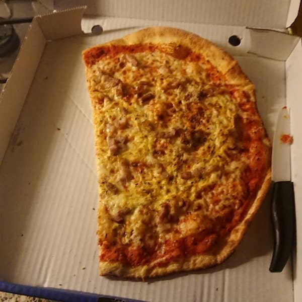 husband cuts pizza into a square