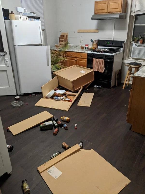 wooden cabinets fell off the wall in the kitchen and left a huge mess