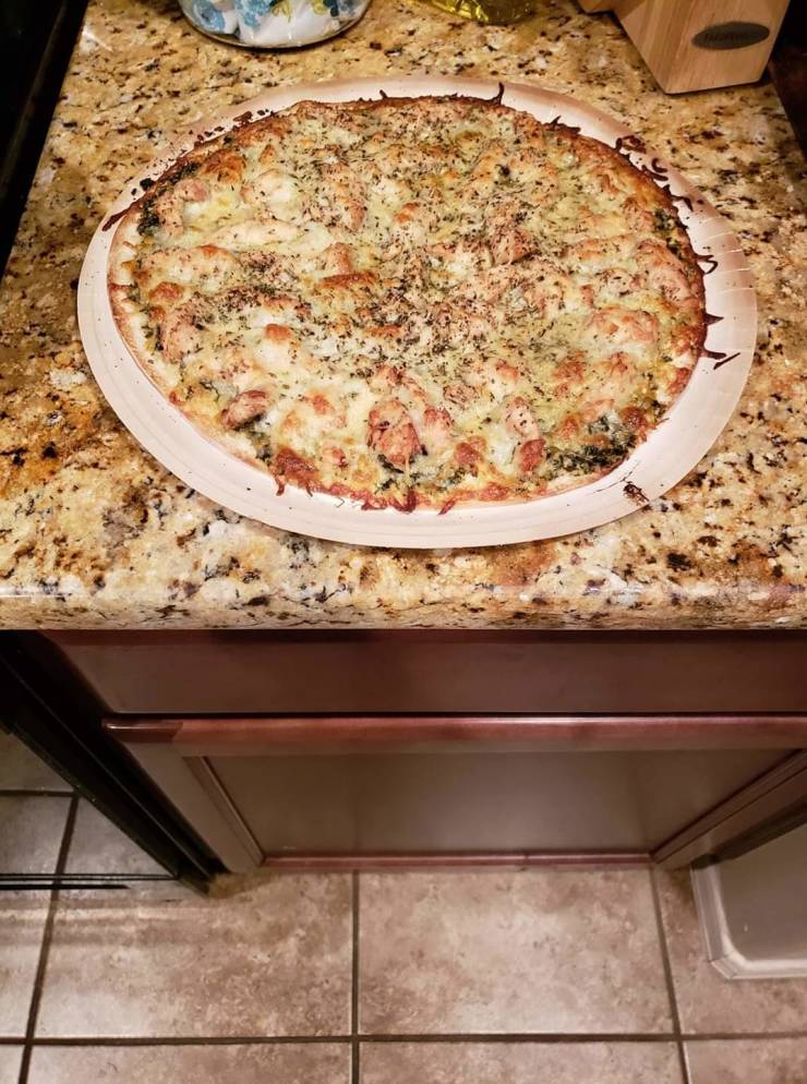 “Pesto pizza camouflaged on the counter.”