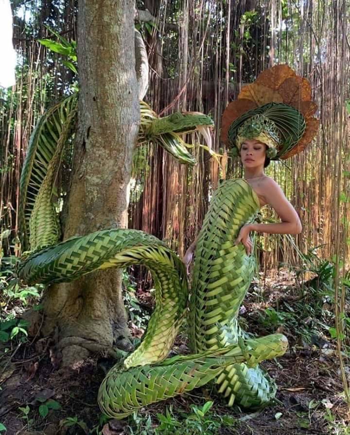 Snake dress made out of palm leaves.