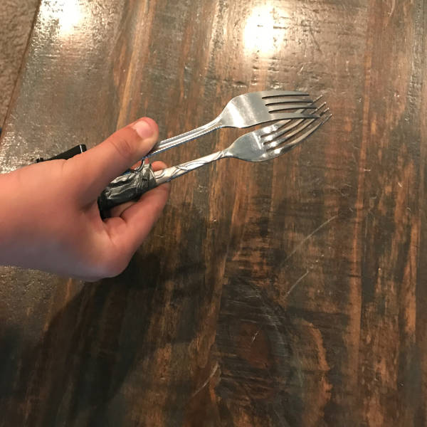 He made a handy pair of tongs by sticking 2 forks together.