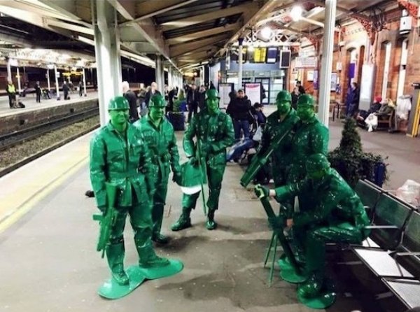 guys dressed as green plastic toy soldiers