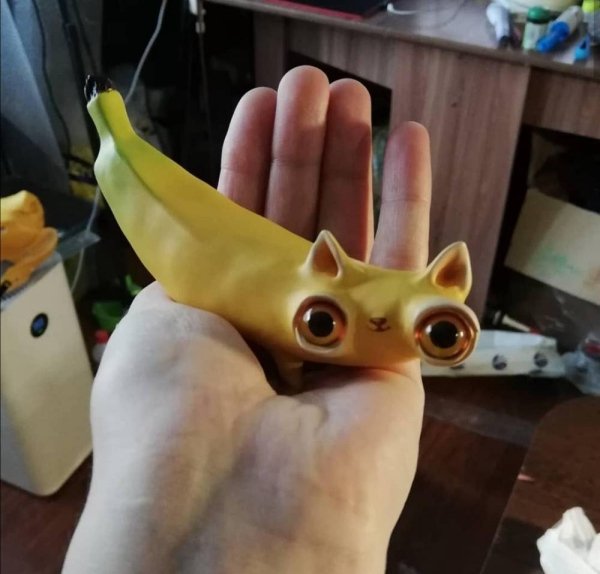 banana sculpture with large eyes and cat ears