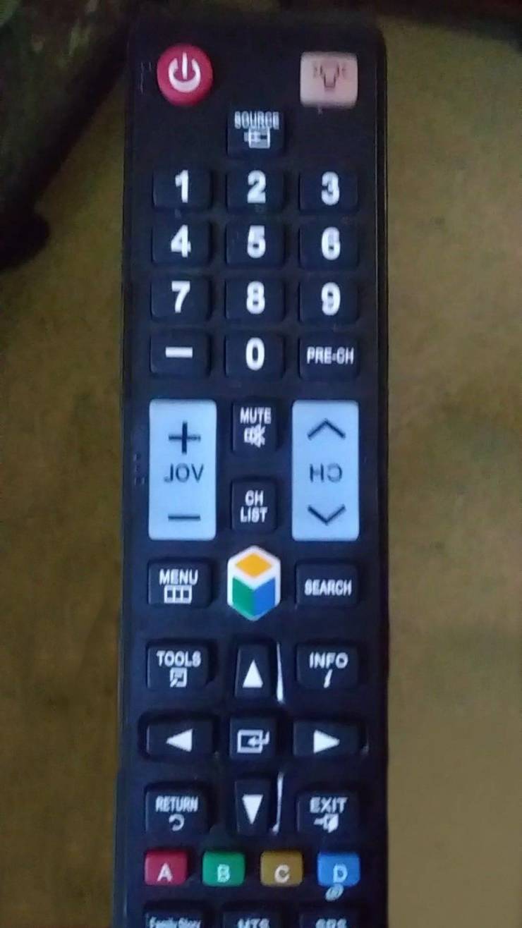tv remote with text printed backwards on it