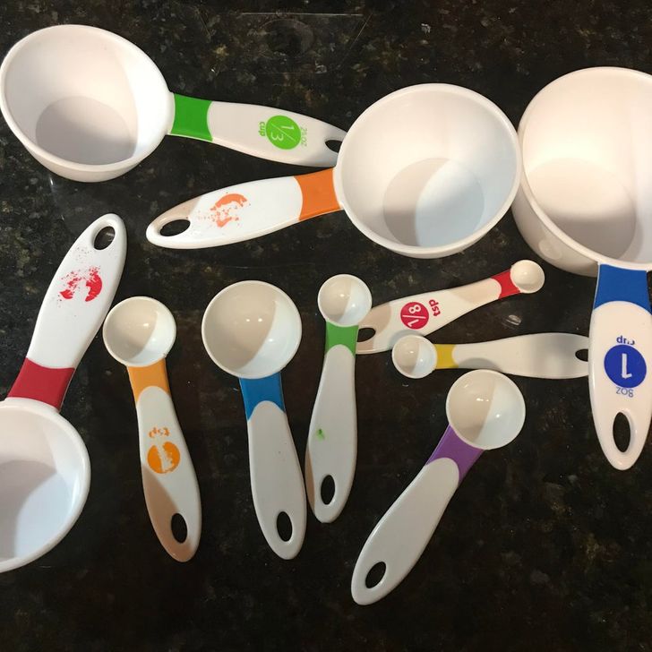 Measuring spoons and cups that are labeled with ink that washes off the first time it touches water