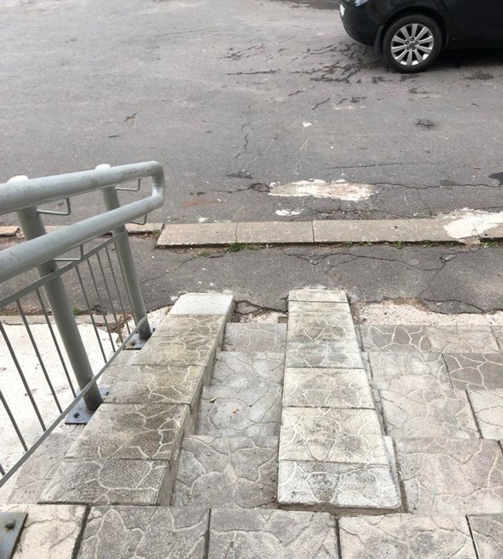 This very steep wheelchair ramp that goes straight into the street