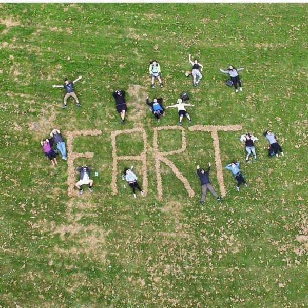 kids spelling fart in the grass