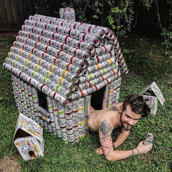 guy in dog house made from white claw cans