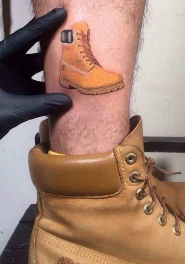 timbs tattoo on ankle of guy wearing timberland boots