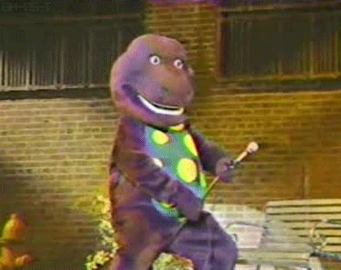 barney the dinosaur pretending the microphone stand is his penis gif