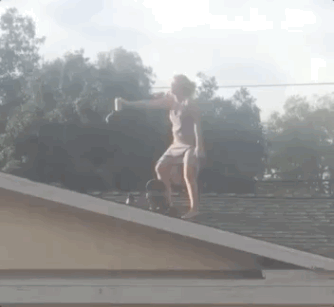 girl skateboarding off roof gif
