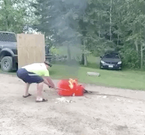 guy blowing up a spray paint can with a hammer gif