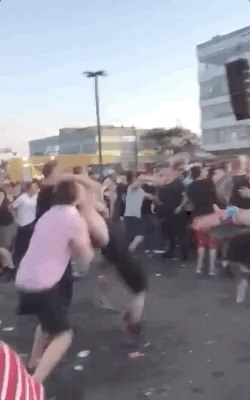 guy falling on the ground in a mosh pit gif