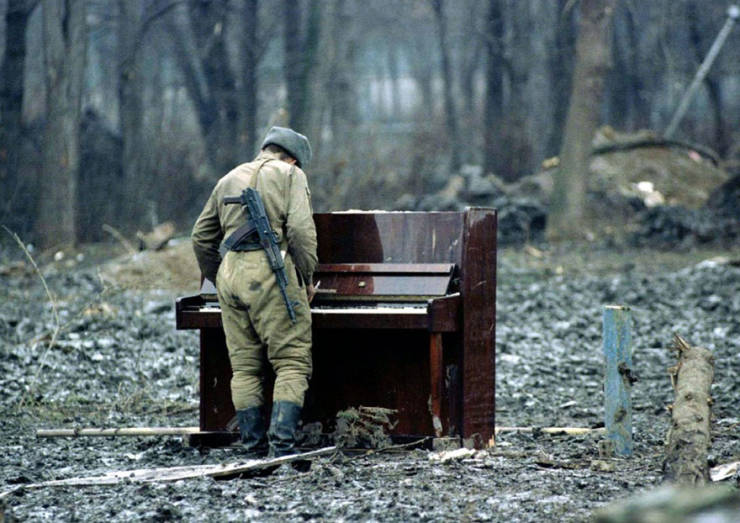 russian soldier playing an abandoned piano