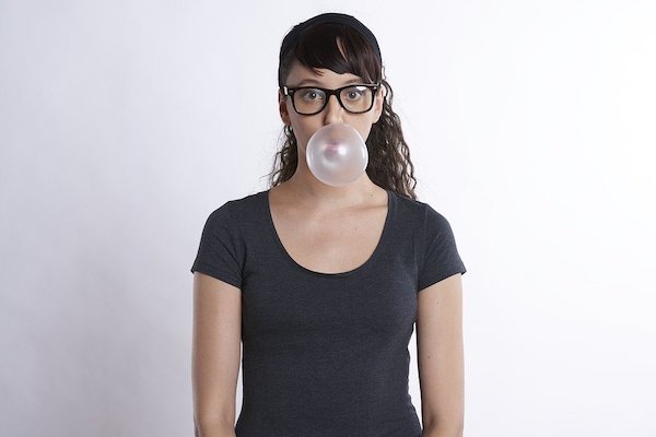 woman blowing bubble gum