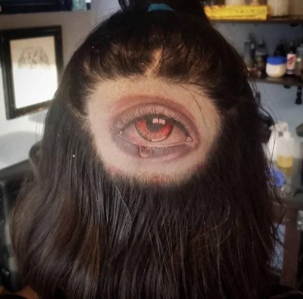 bald spot with eye tattoo on it