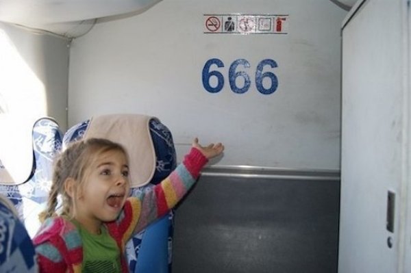 girl pointing to 666 on wall