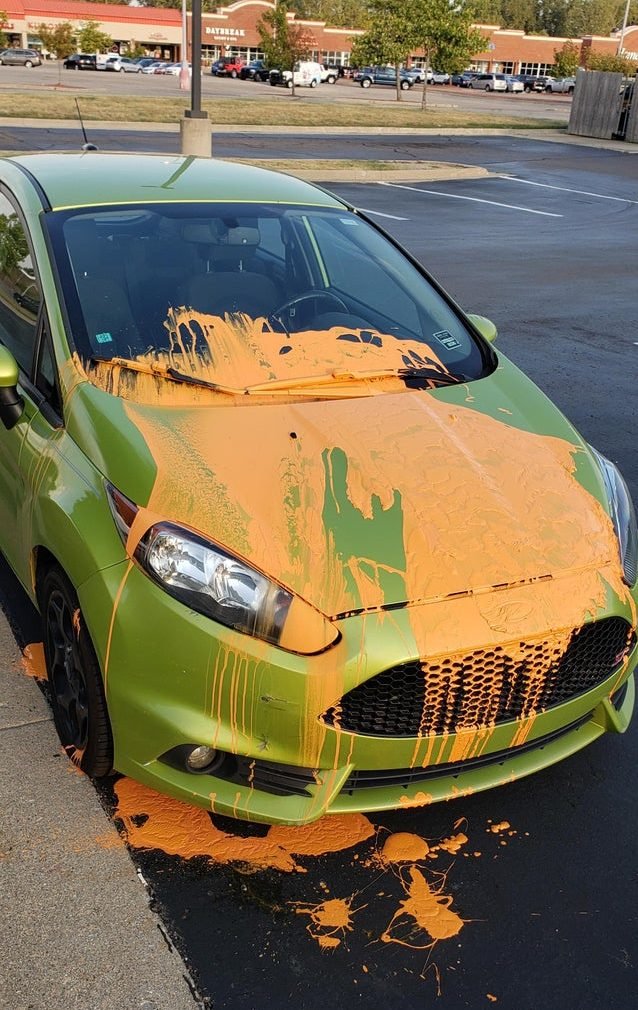 green sports car covered in orange paint
