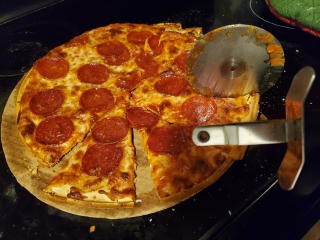 pepperoni pizza with broke pizza wheel