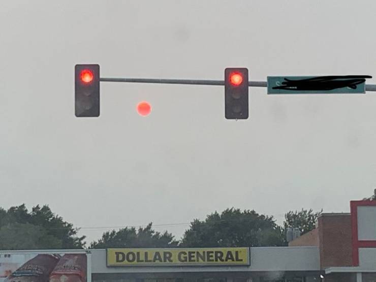 "A red sun next to two red lights"