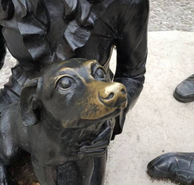 dog statue petted