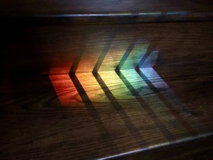 “The way the railing’s shadow divided up the colours of the rainbow reflection on my stairs.”