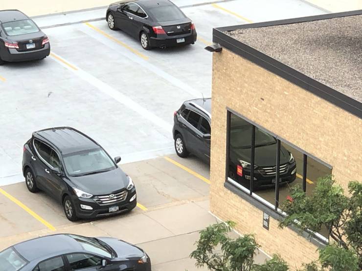 “This car’s reflection in the window that lines up with the car behind the building.”