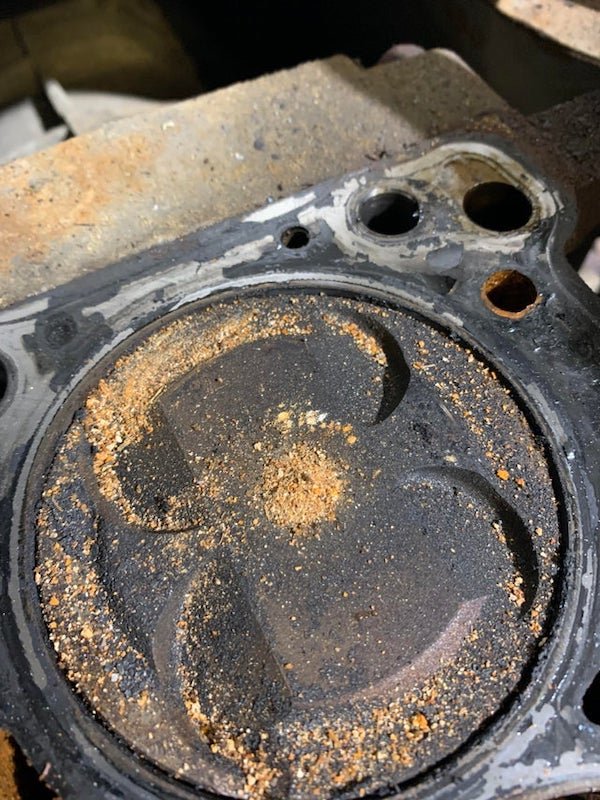 Sand like, but softer (it turn almost paste like when you rub it) stuff found in the cylinder on a MX5 having a new head gasket.

<br/><br/><b>A:</b> Sediment left over from water in the coolant not being distilled