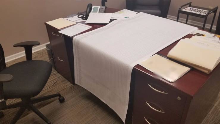 huge paper print out on boss' desk
