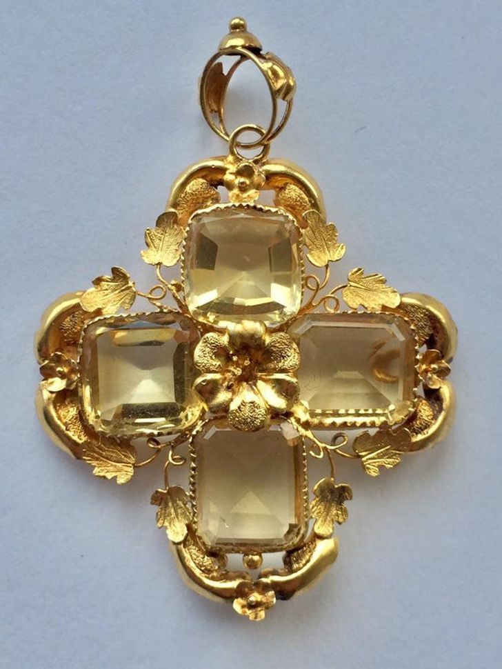 “I found this pendant labeled as costume jewelry for $3. I took it to a jeweler and they said it’s made from unmarked 18k gold while the stones are topaz.”