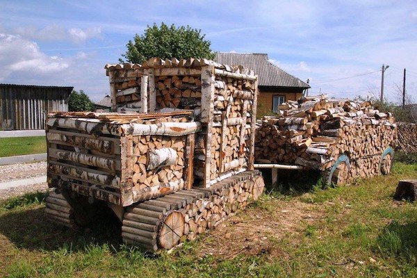 cool pictures - fire wood piled into the shape of a tractor