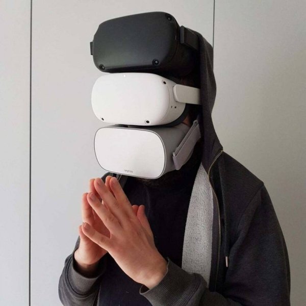 man wearing three VR headsets