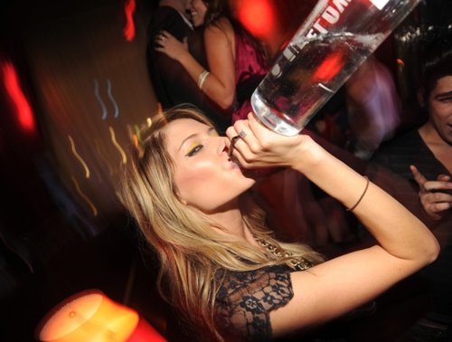girl chugging a bottle of vodka in club