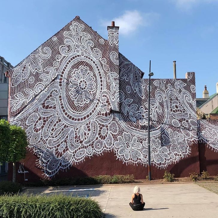 The mural on this building that looks like lace was painted by a street artist in Calais, France.