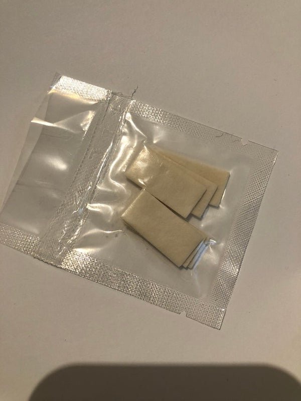 What are these fiberous tabs in a sealed package?

A: They kind of look like anti-fog inserts for Go Pro waterproof housing.