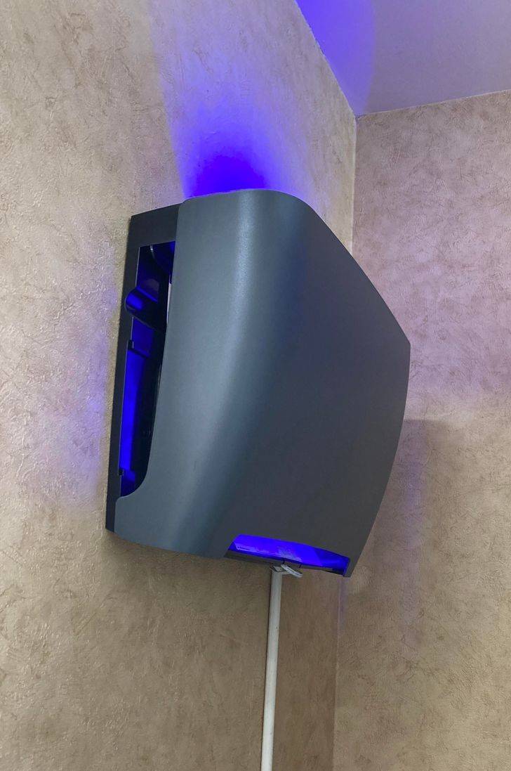 “Spotted in a Culver’s between the wall and a fridge”

A: “It’s a bug trap. There’s a big glue trap behind the panel that traps flying bugs attracted by the light.”